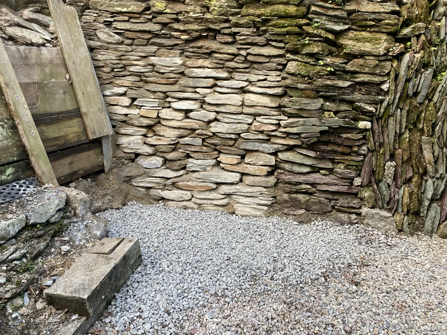 Repaired and rebuilt Cornish stone hedge face with fresh gravel